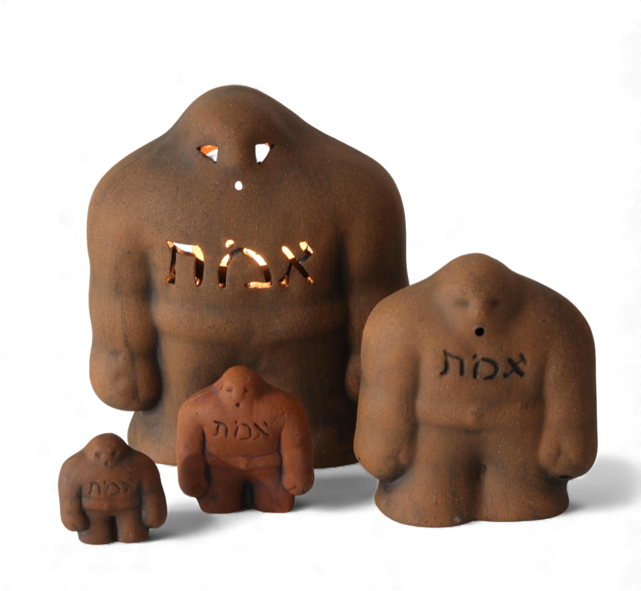 Clay golem figurines with Hebrew letters.